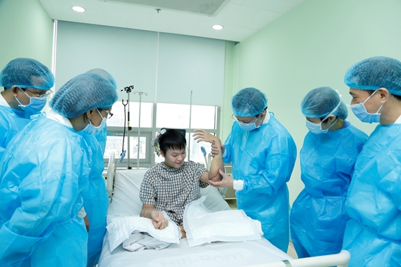 Ban giám đốc Bệnh viện Trung ương Quân đội 108 thăm bệnh nhân được ghép hai cẳng bàn tay sau phẫu thuật. Ảnh: Bùi Thuấn.